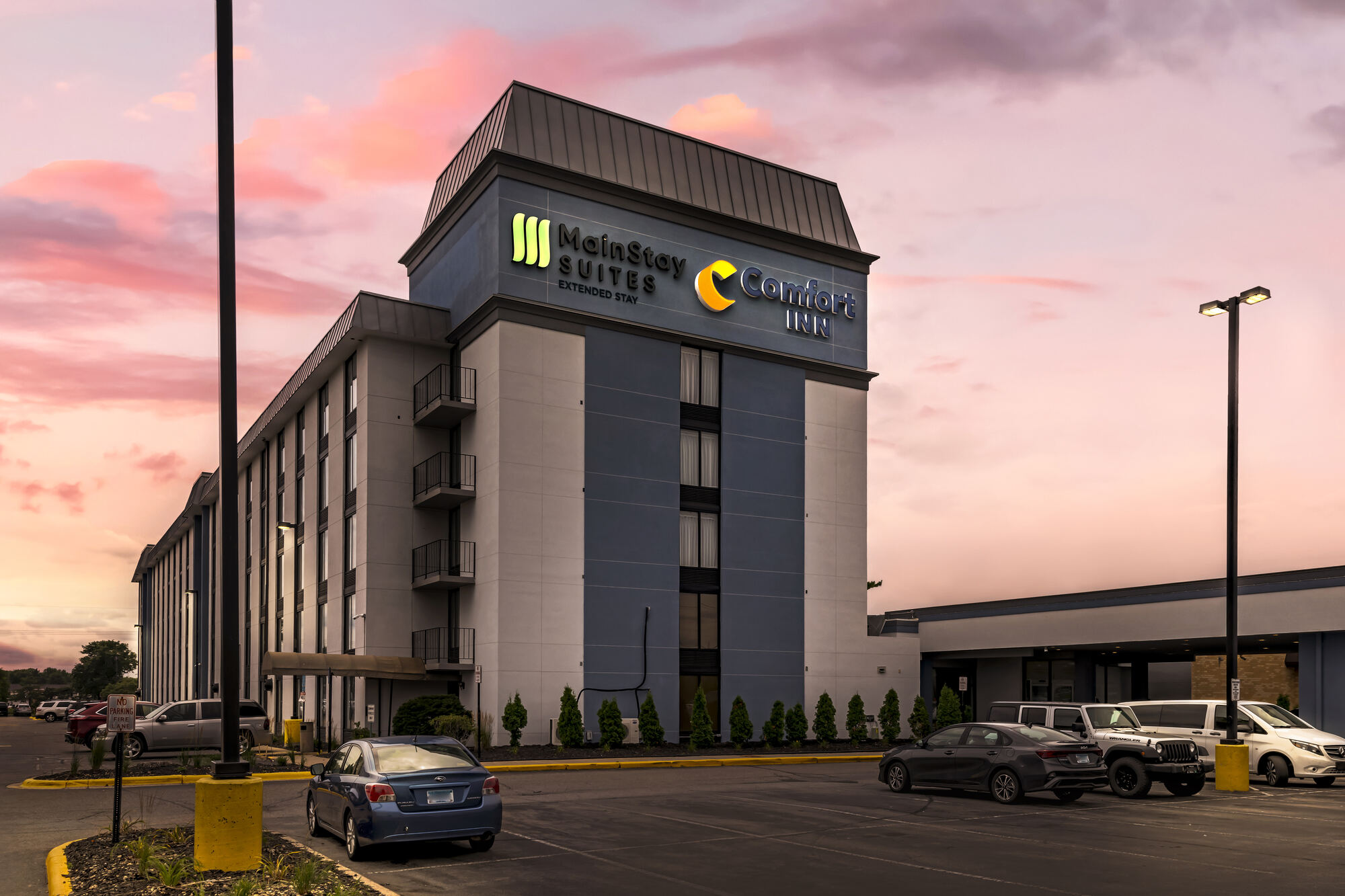 Comfort Inn Bloomington hotel at dusk with Outback Steakhouse on site